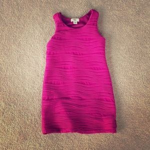 A cute pink dress with texture on the front